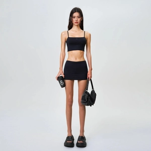 Two-piece black sporty set with thin strap crop top and ruched mini bodycon skirt