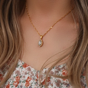 Detailed close-up of a golden leaf-eye pendant necklace featuring marquise-cut zircon