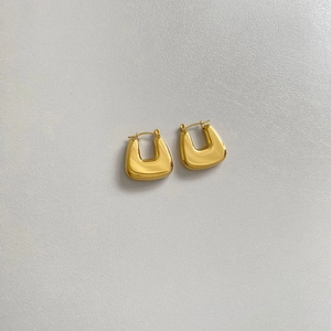 Detailed view of gold plated hollow oval earrings in a minimalist geometric U-shape design