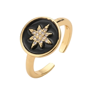 Anello regolabile dorato con smalto nero e zircone a stella su sfondo bianco