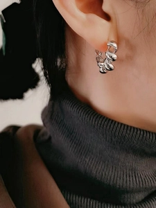 Macro shot of 925 sterling silver hoop earrings with spiral twisted line detail