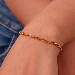 Detail of 18K gold plated long box chain bracelet on wrist with high polish finish