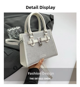 Detailed view of the sparkling silver rhinestones and fashion text on the white square bag