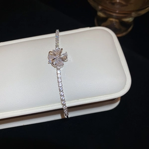 Close-up of silver zircon flower bracelet on a luxury jewelry display box