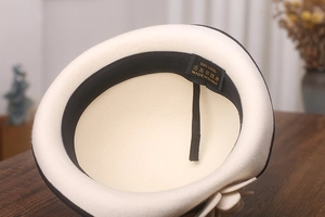 Detail of wool felt hat interior with 100% wool label and adjustable sweatband strap