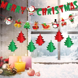 Detail of glitter Merry Christmas banner and 3D paper tree decorations on a window