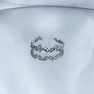 Macro view of adjustable silver twisted chain ring with textured interwoven design