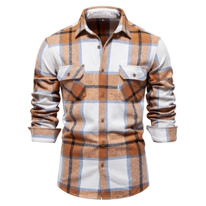 Detailed view of men's brown flannel plaid shirt with buttoned chest pockets and collar