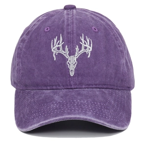Detail of white elk skull embroidery on a purple washed cotton vintage baseball cap