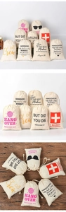 Macro view of canvas hangover kit gift bags with printed slogans on rustic wood