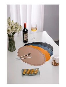 Detailed view of heat-resistant faux leather placemats with embossed Nordic patterns