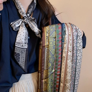 Close-up of printed paisley and geometric silk scarves in various vintage patterns