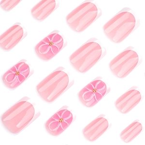 Short square press-on nails with 3D pink flowers and classic French tips on white background