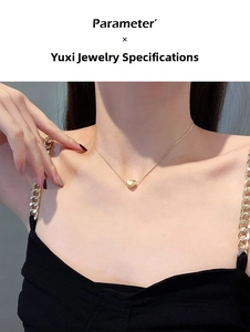 Close-up of a 3D gold heart pendant necklace worn on a neck highlighting sleek style