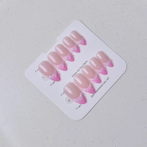 Detail of nude pink press-on nails with 3D flame textures on white display card