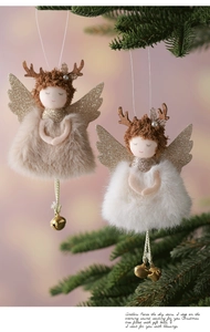 Detail of plush Christmas angel ornaments with faux fur and bells on pink background