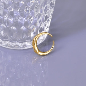 Adjustable irregular gold open ring with a flowing metal texture on a purple reflective base