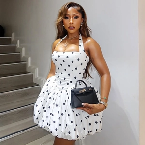 Detailed view of white polka dot halter dress with smocked waist and flared bubble hem