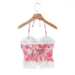 Detailed view of pink floral crop top featuring delicate white lace trim and ruffles