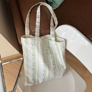 Macro view of floral pattern and woven label texture on cotton tote bag fabric