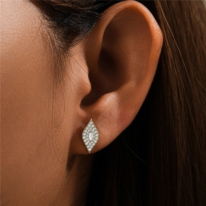 Macro view of gold marquise earrings with white zircon paving on a female model