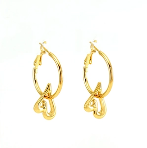 Detailed view of gold plated hoop earrings featuring a polished hollow heart pendant