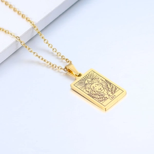 Close-up of gold stainless steel Leo necklace with engraved lion and sunburst detail