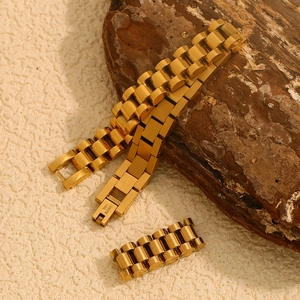 Macro detail of 18K gold plated stainless steel watchband style ring on stone background