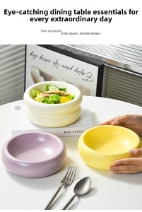 Close-up of thick ceramic donut bowls in purple, yellow, and cream with soft matte glaze