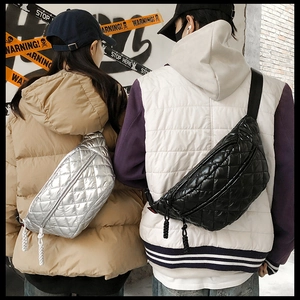 Detail shot showing silver and black quilted crossbody waist bags on models in a street setting