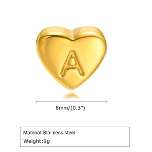 Detail view of a golden stainless steel heart charm with letter A engraving and size metrics