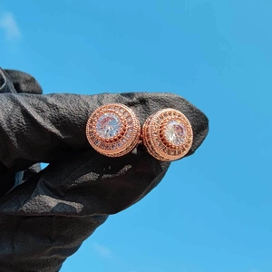 Close-up of rose gold iced-out round stud earrings with premium cubic zirconia crystals