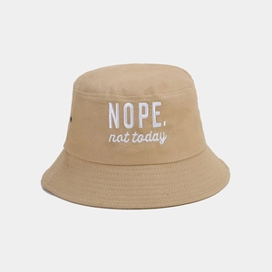 Detail of khaki cotton bucket hat with white NOPE. not today embroidery and metal eyelets