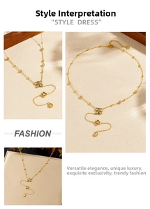 Detail of gold butterfly Y-necklace with sparkling diamonds and teardrop pendant charm