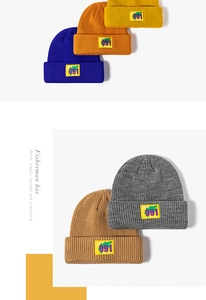 Detail showing various colors of knitted fisherman hats with embroidered square patch