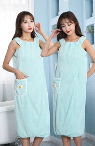 Detail of mint green wearable bath towel with white trim and daisy embroidery pocket