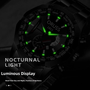 Macro view of matte black chronograph watch showing luminous hands and green glow markers
