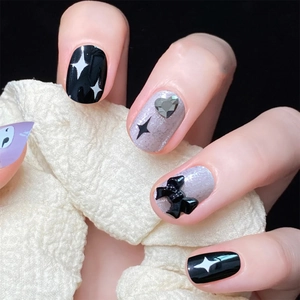 Star pattern press-on nails with 3D bows and heart rhinestones in purple and black