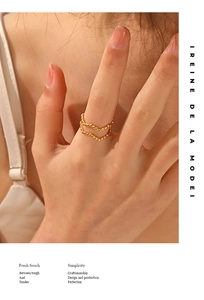 Detail of double-row beaded 18K gold plated ring with wave design on finger