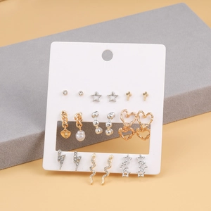 Set of 9 pairs of gold and silver fashion earrings with pearls and mixed charm designs