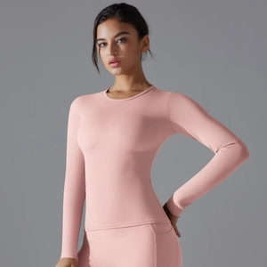 Close-up of pink slim fit long sleeve yoga top with high elastic matte texture fabric