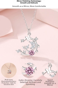 Detail view of S925 silver necklace featuring a crescent moon, butterfly, and pink cubic zirconia