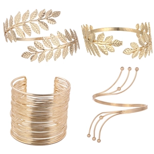 Set of four gold leaf and spiral arm cuffs in various metallic bohemian designs