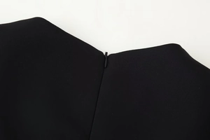 Macro shot of a high-quality invisible zipper closure on the black stand collar dress