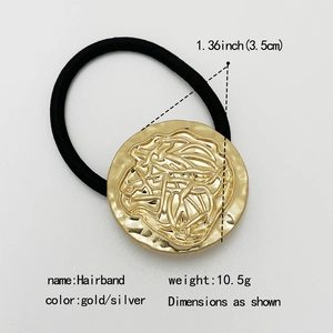 Minimalist elastic hairband with circular gold metal charm and black ponytail tie for women