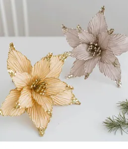 Close-up of champagne gold sequined poinsettia flowers with glittery velvet petals