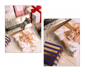 Detail of assorted gold foiled gift wrapping paper with feather and wave patterns