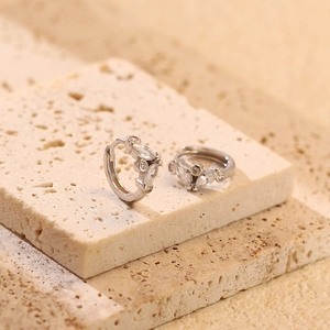 Detailed macro view of S925 silver hoop earrings with marquise diamonds on stones
