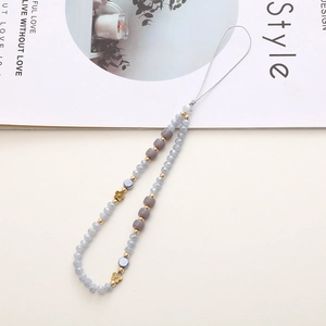 Detail of beaded phone strap with grey and lavender crystals and golden flower accents