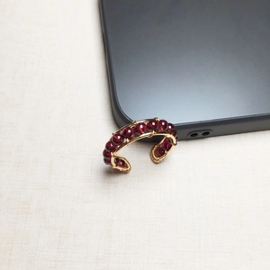 Macro detail of 14K gold filled wire wrapped earrings with deep red garnet beads